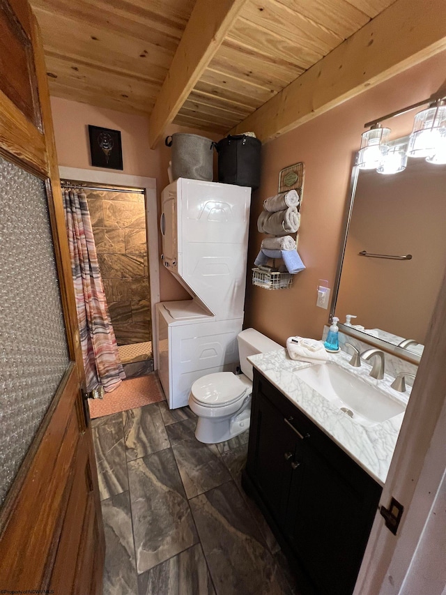 bathroom with vanity, wooden ceiling, stacked washer and clothes dryer, toilet, and beamed ceiling