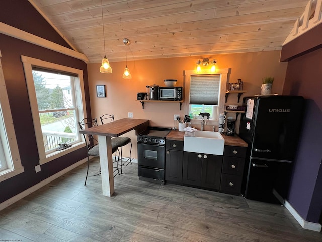 kitchen with light wood-type flooring, wood ceiling, sink, black appliances, and decorative light fixtures