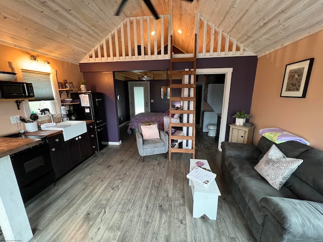 living room with wood-type flooring, vaulted ceiling, wood ceiling, and sink