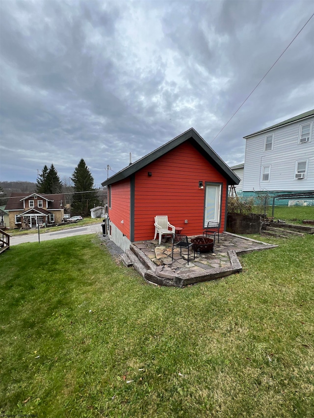 view of side of property with a lawn and a patio area