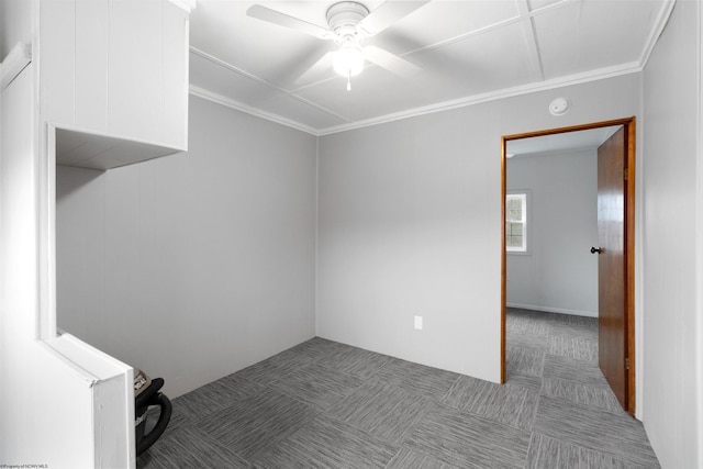 spare room featuring ceiling fan and ornamental molding