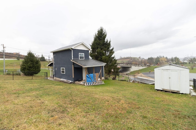 view of yard featuring a water view and a shed