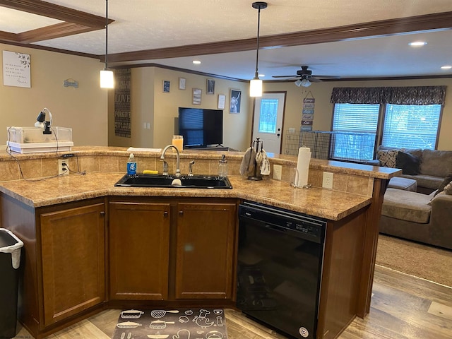 kitchen featuring crown molding, sink, pendant lighting, and black dishwasher