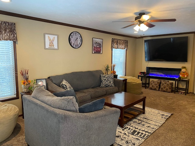 carpeted living room with plenty of natural light, ornamental molding, and a ceiling fan