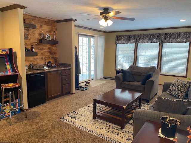 carpeted living room with wooden walls, indoor bar, ceiling fan, ornamental molding, and a textured ceiling