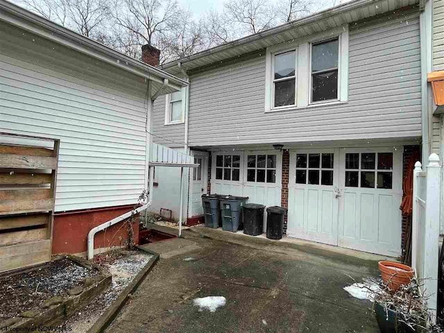 back of property with a garage