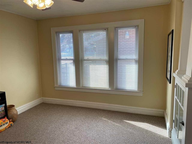 unfurnished room featuring carpet flooring, a wealth of natural light, and ceiling fan