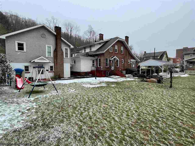 back of house featuring a playground