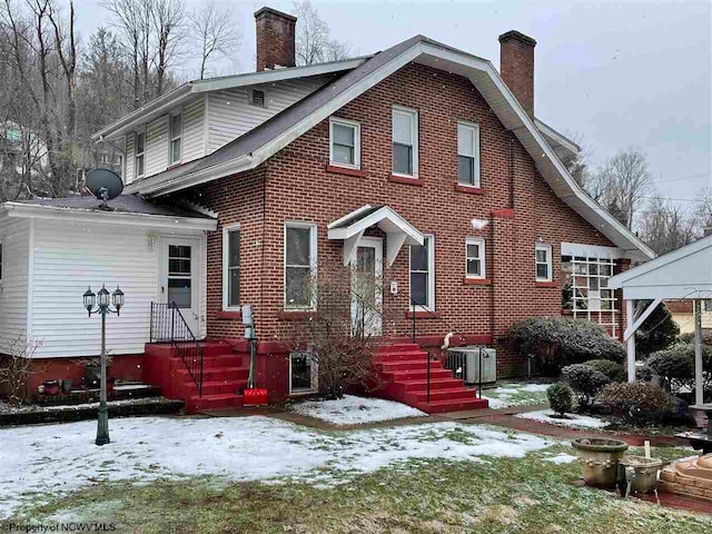 view of snow covered back of property