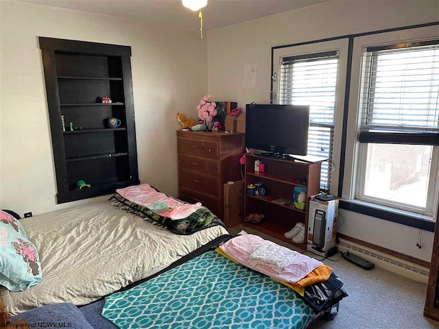 bedroom featuring carpet floors and a baseboard heating unit