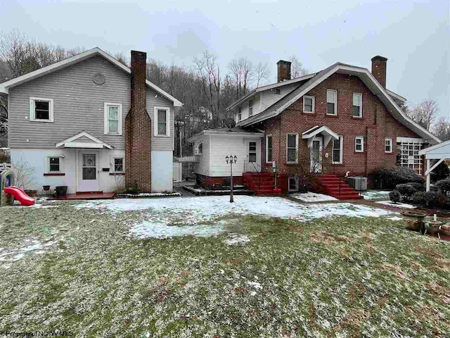 snow covered house with cooling unit