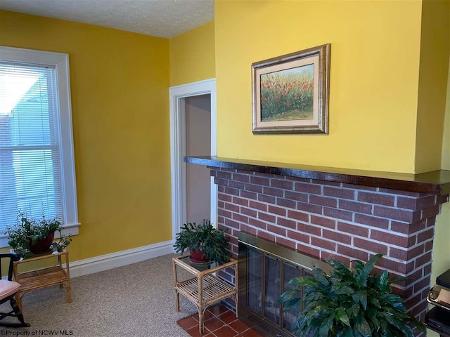 interior details featuring carpet and a brick fireplace