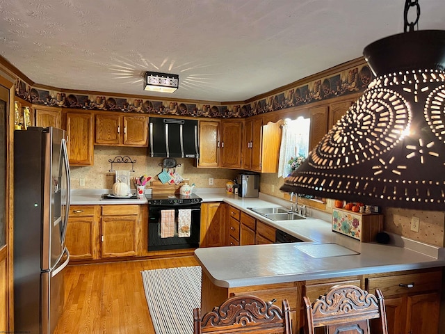 kitchen featuring stainless steel fridge, light wood-type flooring, ventilation hood, sink, and black electric range oven