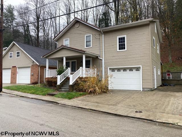 front of property with a porch and a garage