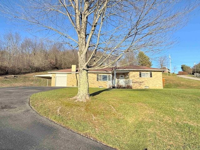 single story home featuring a carport and a front lawn