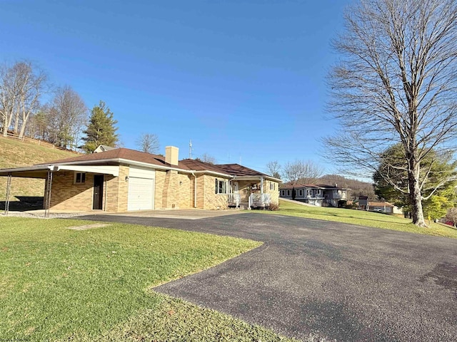 ranch-style home with a front yard, a garage, and a carport