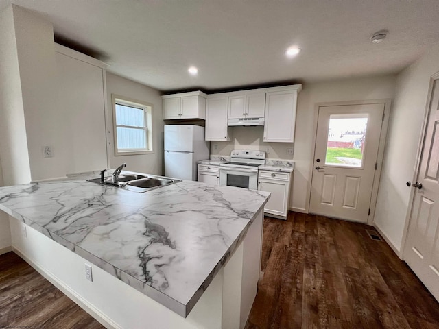 kitchen with white cabinets, dark hardwood / wood-style flooring, white appliances, and sink