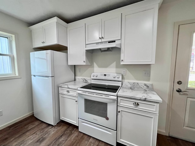 kitchen with a wealth of natural light, white cabinets, and white appliances