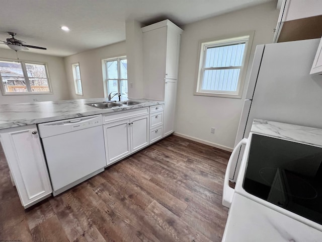 kitchen featuring white cabinets, a healthy amount of sunlight, white appliances, and sink