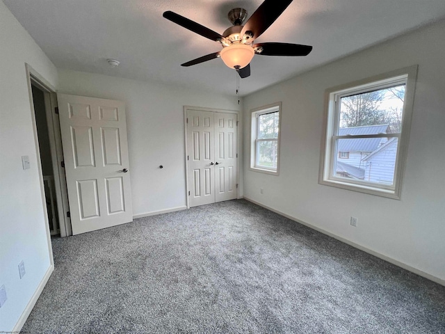 unfurnished bedroom featuring carpet and ceiling fan