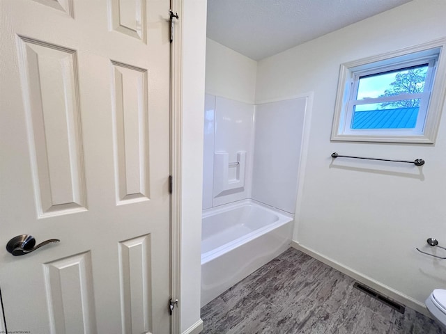 5 River St, Elkins, WV 26241 - full bath featuring wood finished floors, toilet, baseboards, and bathing tub / shower combination