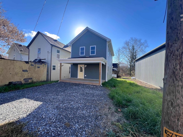 rear view of house with covered porch