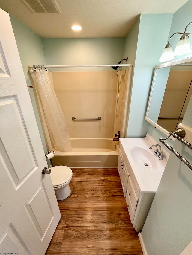 full bathroom with vanity, hardwood / wood-style flooring, toilet, and shower / bathtub combination with curtain