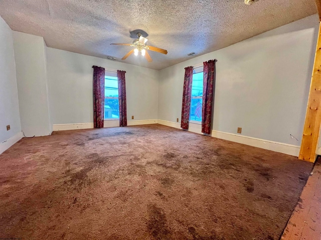 unfurnished room featuring ceiling fan, carpet floors, and a textured ceiling