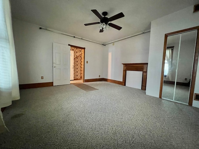 unfurnished room with carpet flooring, a wealth of natural light, and ceiling fan