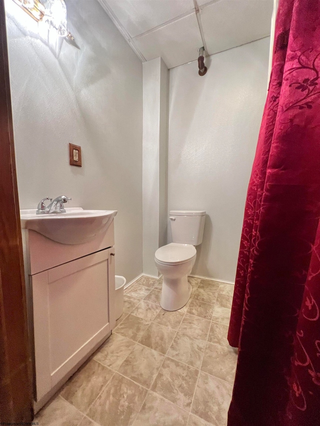 bathroom featuring tile patterned flooring, vanity, and toilet