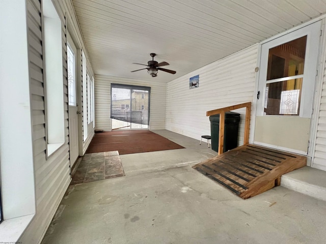 unfurnished sunroom with ceiling fan