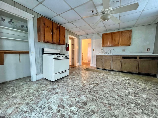 kitchen with white gas range, a paneled ceiling, sink, and ceiling fan