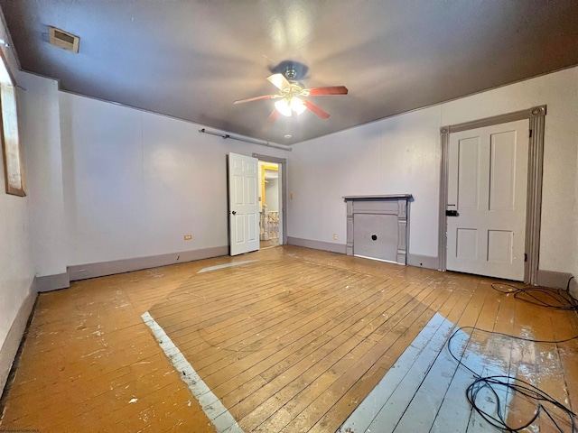 empty room featuring ceiling fan and light hardwood / wood-style floors