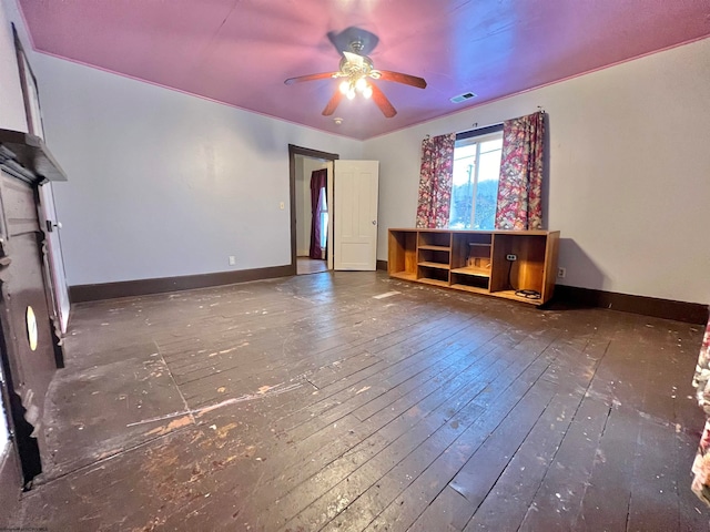 unfurnished living room with dark hardwood / wood-style floors and ceiling fan