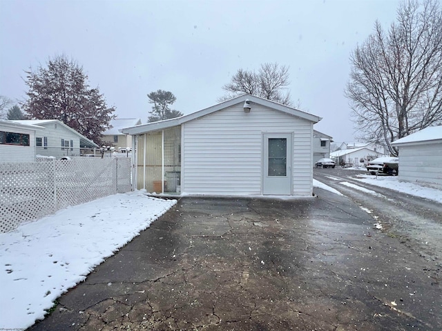 view of snow covered rear of property