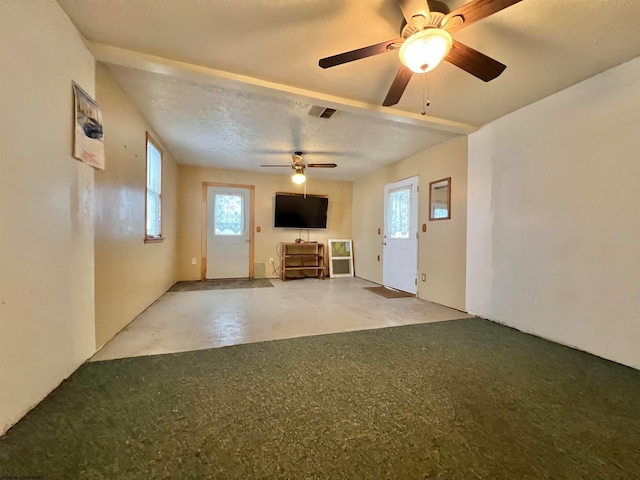 unfurnished living room featuring a textured ceiling and ceiling fan