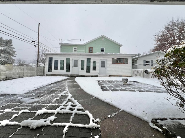 view of snow covered back of property