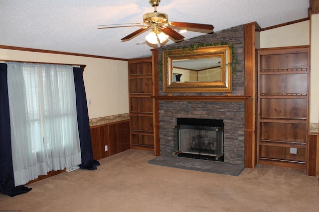 unfurnished living room featuring carpet, wood walls, ceiling fan, and a textured ceiling