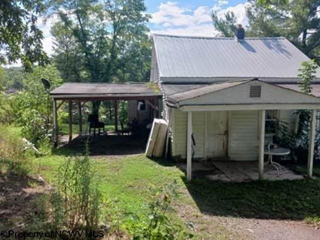 back of property featuring a yard