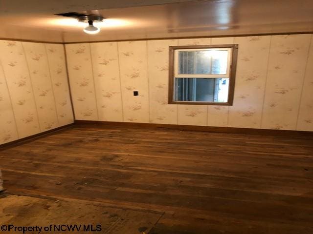 empty room featuring dark hardwood / wood-style flooring