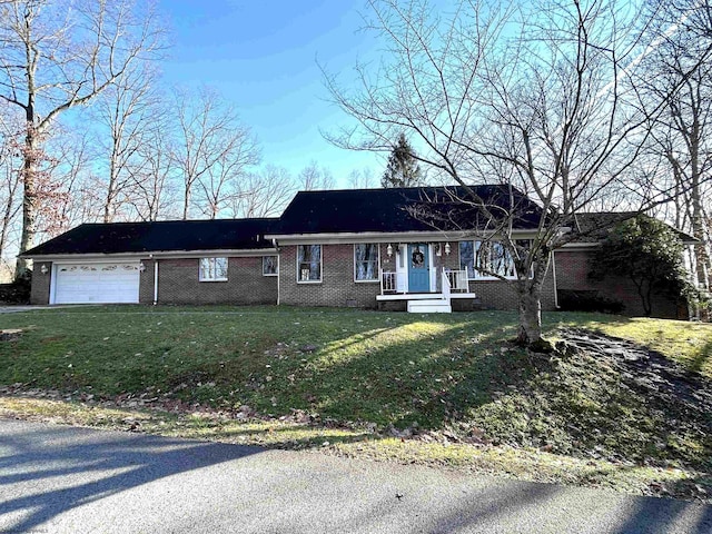 single story home featuring brick siding, an attached garage, and a front lawn