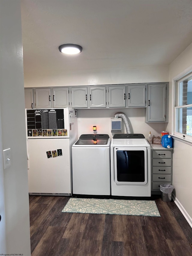 washroom with washer and clothes dryer and dark wood-type flooring