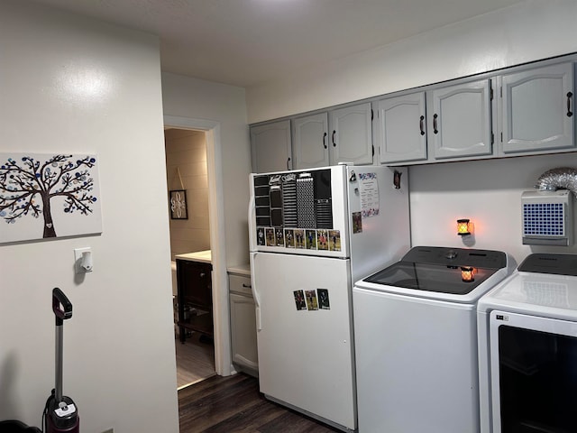 laundry area featuring independent washer and dryer and dark wood-type flooring