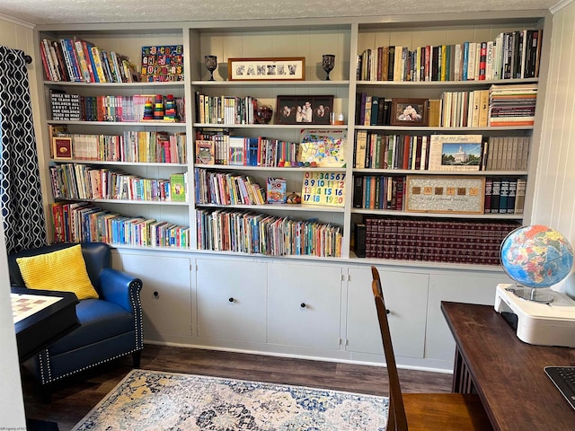 sitting room with dark wood-type flooring and a textured ceiling