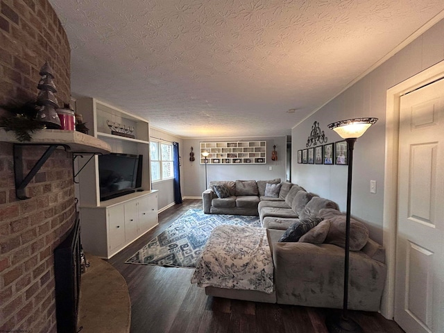 living room featuring a textured ceiling, dark hardwood / wood-style flooring, a brick fireplace, and lofted ceiling