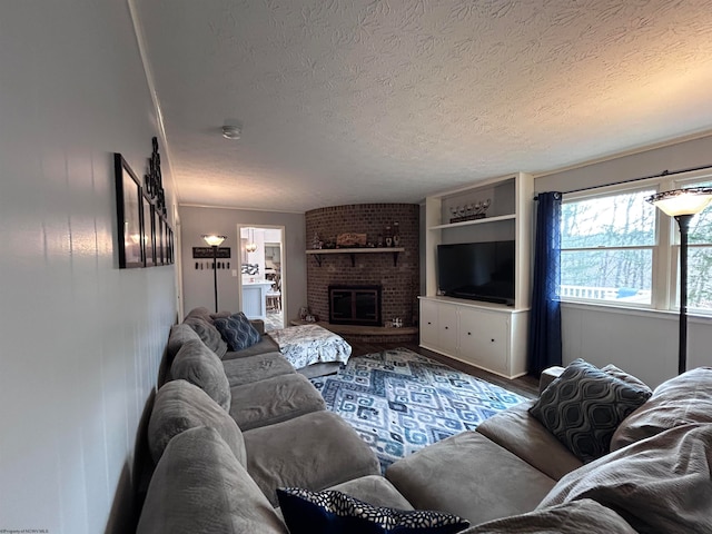 living room featuring a textured ceiling and a brick fireplace