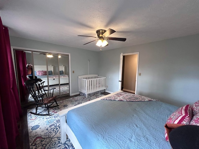 bedroom featuring carpet flooring, ceiling fan, and a textured ceiling