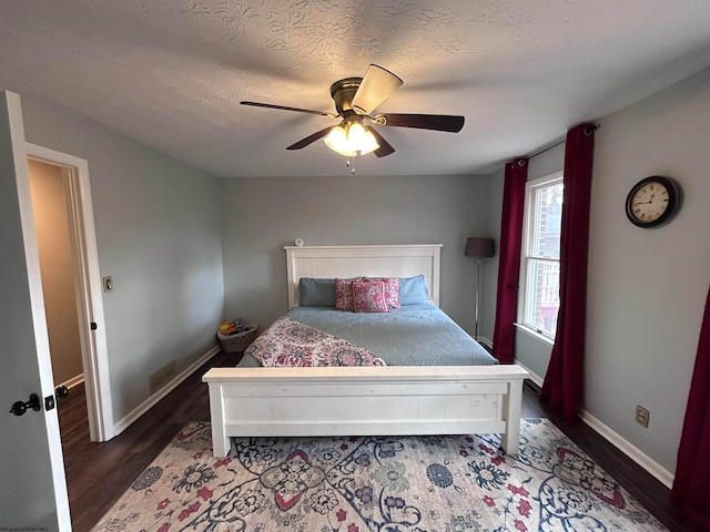 bedroom with dark hardwood / wood-style floors and ceiling fan