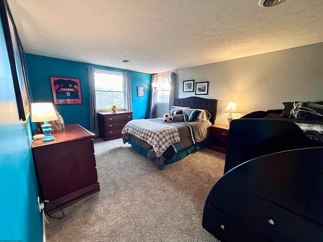 carpeted bedroom featuring a textured ceiling