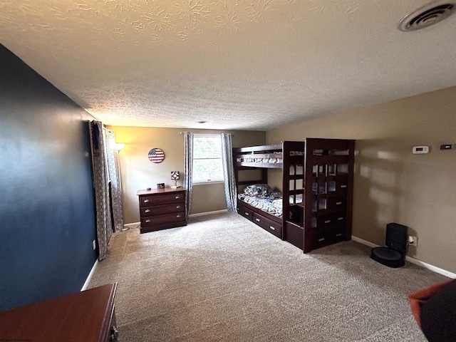 carpeted bedroom with a textured ceiling